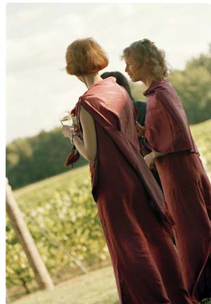 The bridesmaids, comfortable and elegant in their hemp gowns and artisan-crafted Thai shawls, relax in the vineyard after the ceremony.